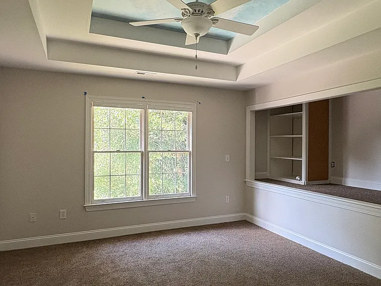 Large upstairs bathroom has shelves and a stage area for sleep-overs or to stage a play or organize packing for a trip.