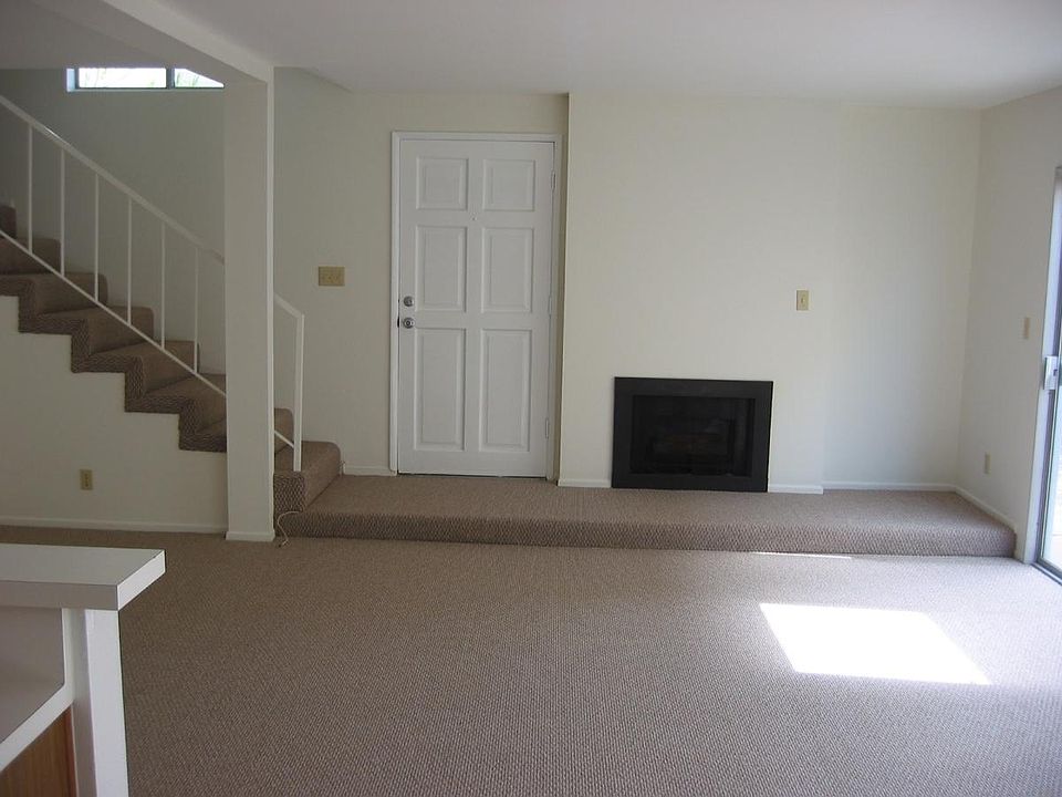 Downstairs family room, fireplace, and entry door