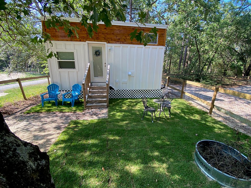 Table and chairs in well manicured yard, and Fire ring for relaxing in front of a fire.