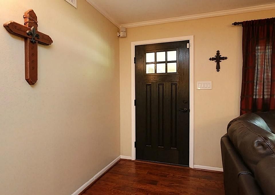 Beautiful entry way with wood front door.