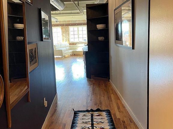 Standing in front of half bath next to entry way hall