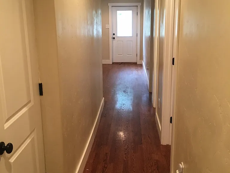 View from the hallway back by the master suite (laundry room to the left and other bedrooms to the right)