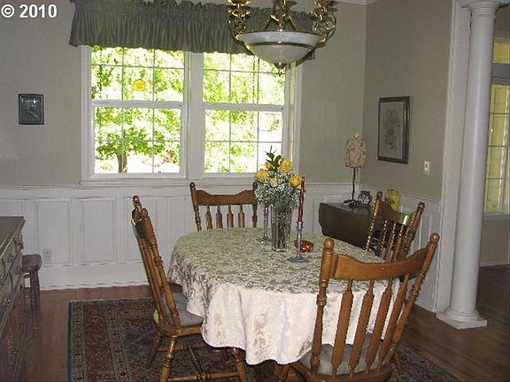 Formal Dining Room with crown molding and paneled wainscoting