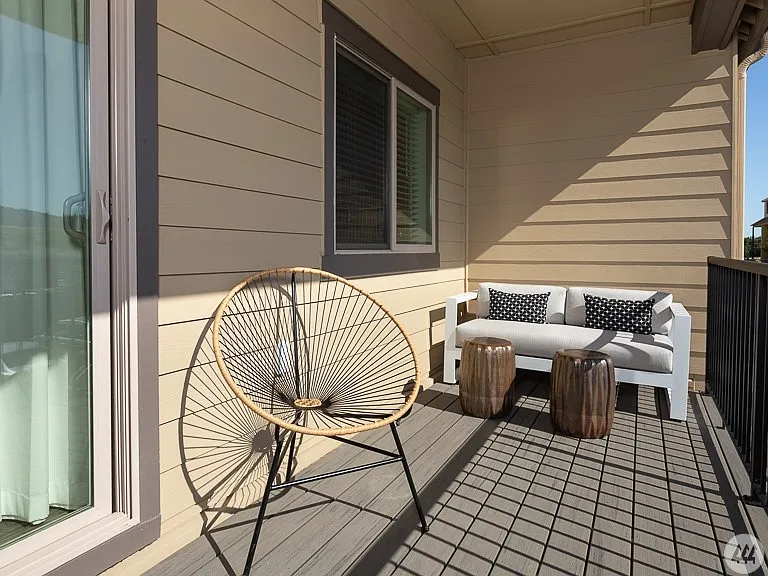 Private covered balcony with space for outdoor seating - the perfect place to enjoy your morning coffee, unwind after a long day, or take in the fresh air year-round.