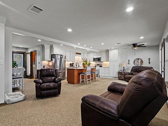 Living room featuring recessed lighting, light carpet, and a ceiling fan