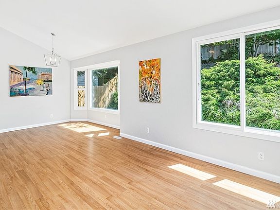The soaring ceilings and laminate floors combine with the bay window in the dining and living rooms as part of this Great Room Open Concept Floor Plan. Light filled, with Recent Updates a Move in Ready Home!