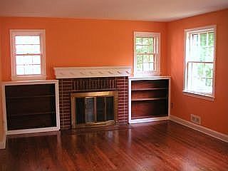 Living room has working fireplace, built in bookcases (after floors refinished