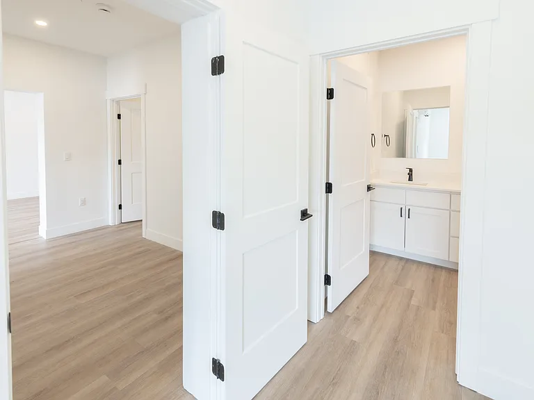 View from Primary bedroom to flex bonus room with main living room beyond. (2-bedroom unit)