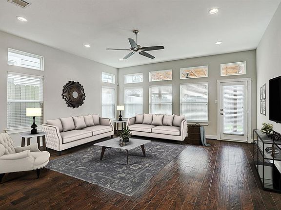 First floor living is at its finest in this spacious living room with endless natural light and gorgeous hardwood flooring. The hardwood floors flow throughout the entire house, including the second floor.