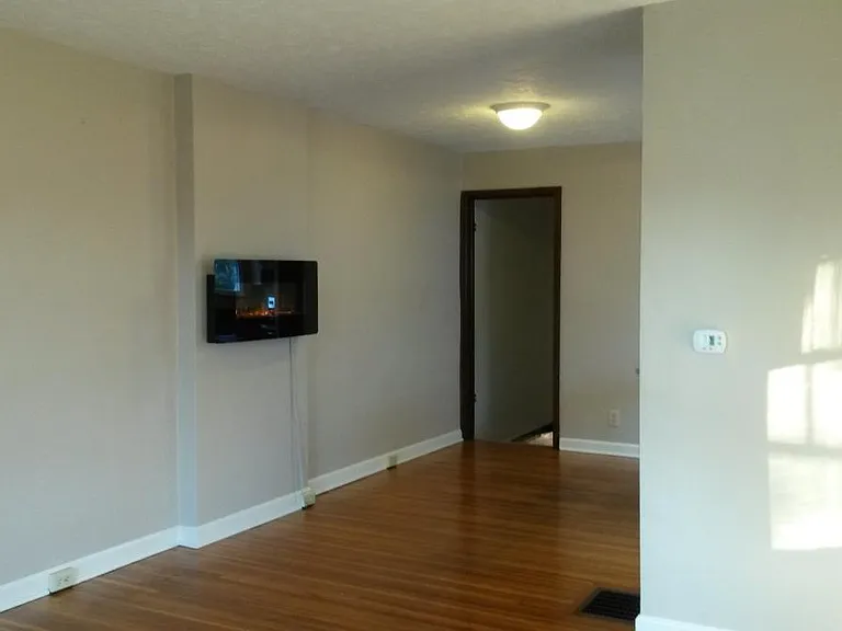 Living area facing back of home with electronic fireplace