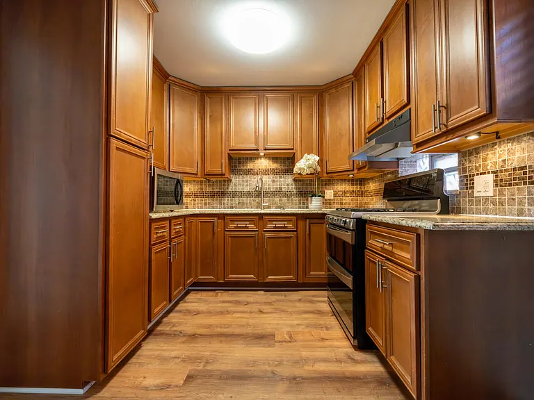 Kitchen includes stove, microwave, and refrigerator, garbage disposal in sink. Note:No Dishwasher