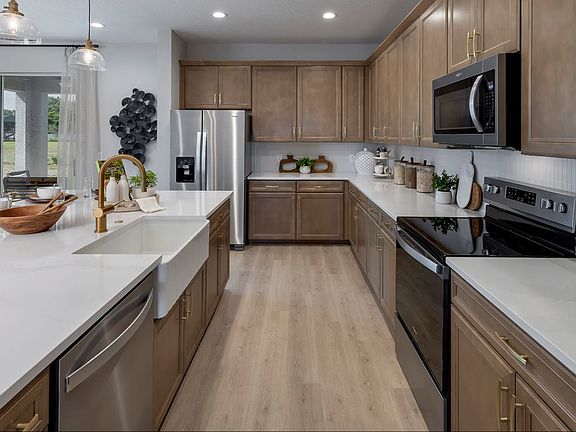 Model Home Kitchen. 
Home for rent has white cabinets and tile floors.