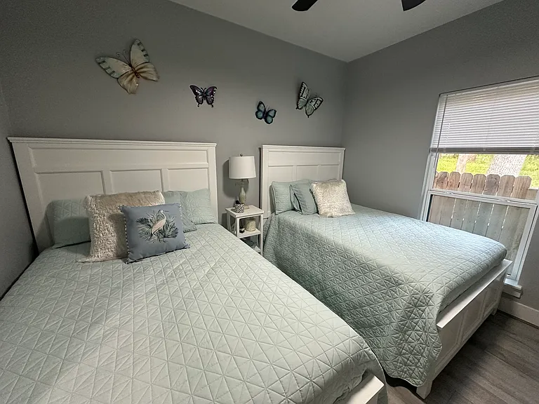 3rd bedroom with 2 double beds and TV.