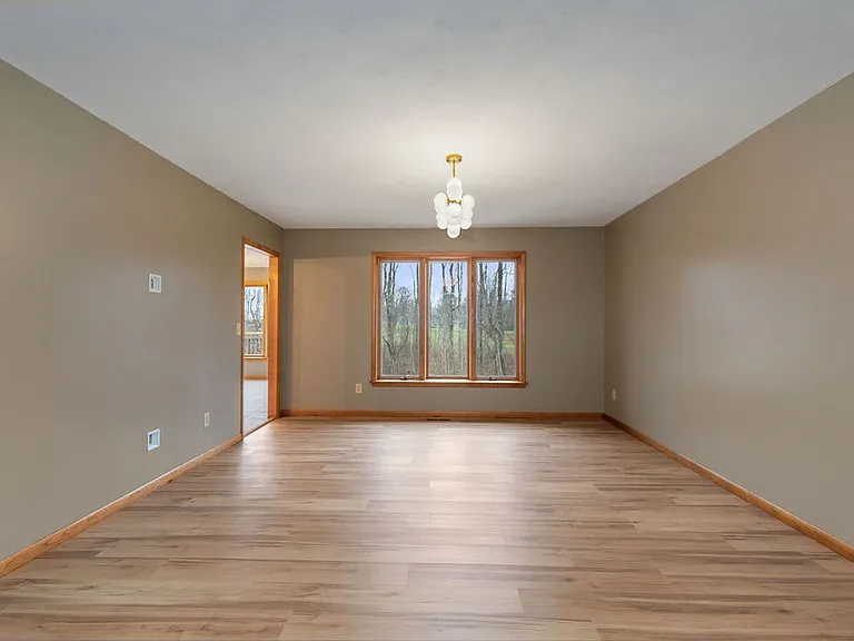 Dining room is large and would easily accommodate a table for eight or more