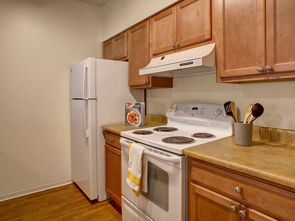 Oven, stove, and refrigerator surounded by beautiful cabinetry