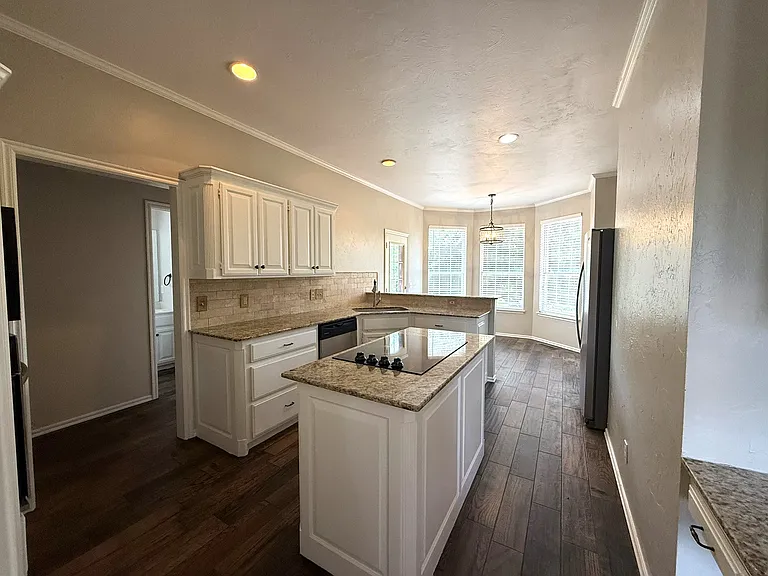 Reverse view of the kitchen towards the breakfast nook with updated paint.
