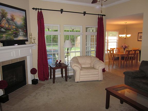 Spacious Great Room-Gas log fireplace, crown molding, high ceiling.