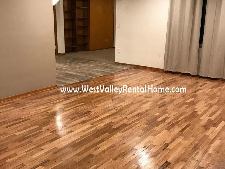 Giant, welcoming living room with brand new, beautiful, energy efficient window treatments and newly finished hardwood floors!