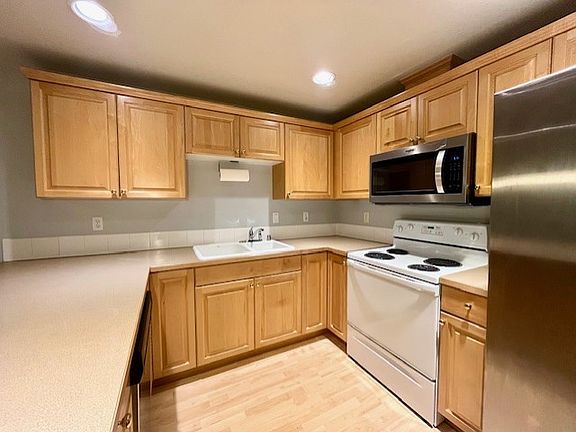 Spacious kitchen with brand new stainless steel microwave and 2 year new refrigerator