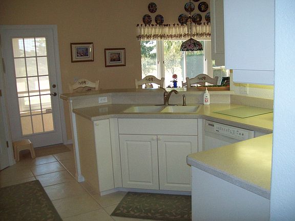 Kitchen w/french door to lanai, also breakfast nook w/aquarium glass window