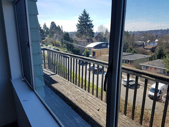 Facing South West, view of the deck and neighborhood out of the bedroom window.