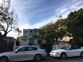 Unit is behind small house in front