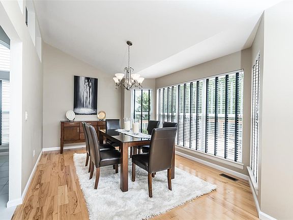 Vaulted dining room with bay window to composite deck