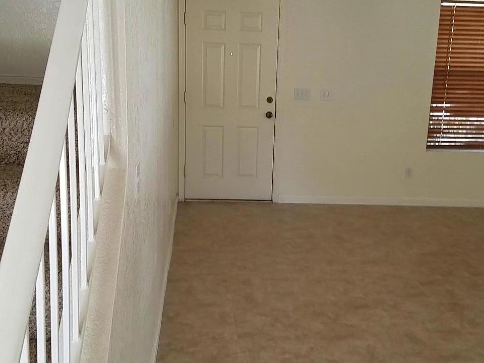 Front entry into Living room. Tiled throughout bottom floor.
