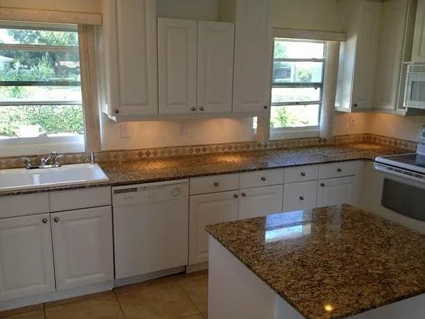 Kitchen with granite countertops, lots of cabinet and drawer storage