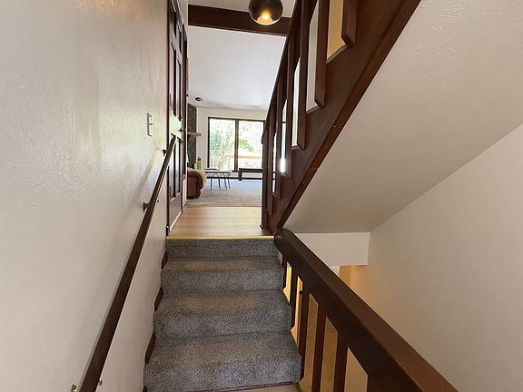 View of main entrance and living room from basement stairs