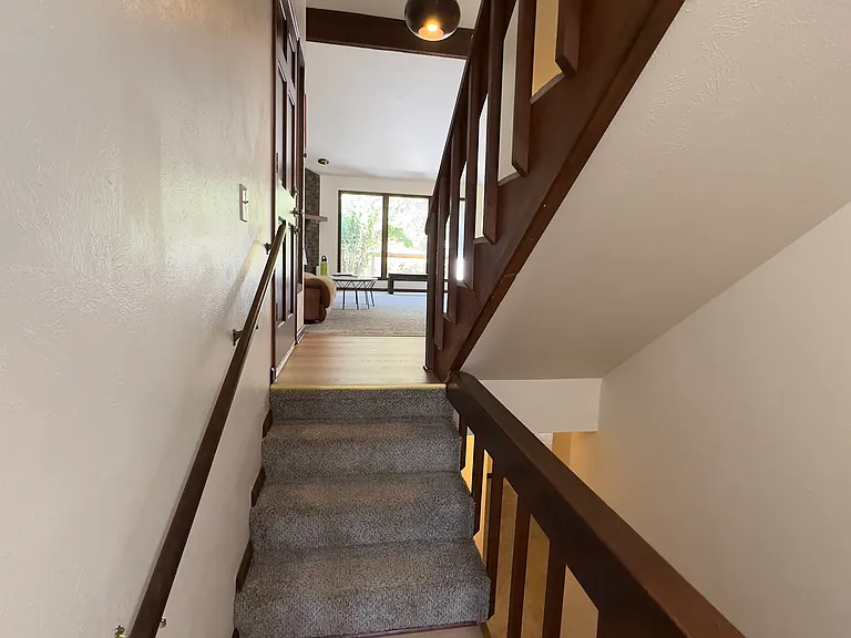 View of main entrance and living room from basement stairs