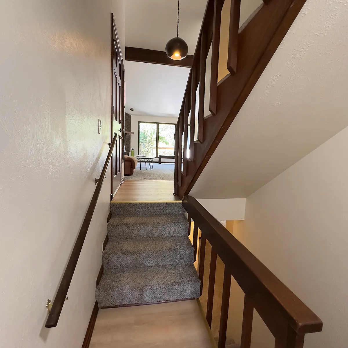 View of main entrance and living room from basement stairs - 3985 Apache Ct E