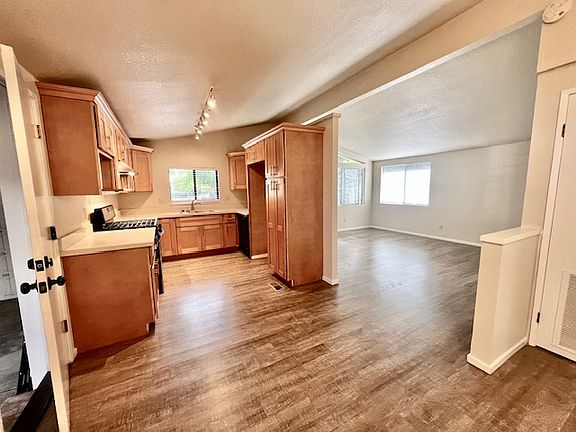 Kitchen w/Lots of storage cabinets. Dishwasher and stainless steell refrigerator- stove with oven cleaning feature, stainless steel sink-
Large dining area and spacious great room.