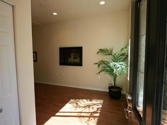 Cheerful sunny entry to studio. South facing windows insure natural light even on cloudy days. Coat closet shown on left.