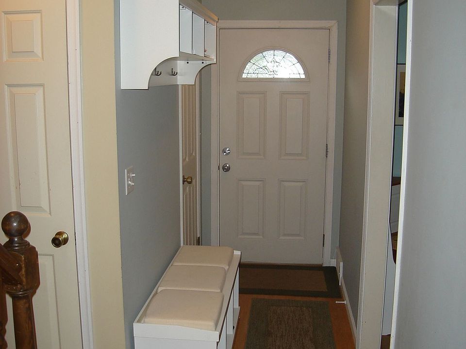 Entryway; kitchen on right; half bath on left; stairscloset on left foreground