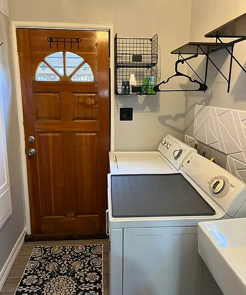 Laundry room with storage and place to hang clothes.