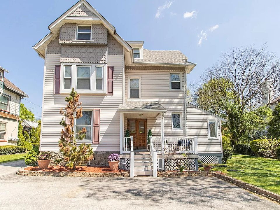 Exterior view of a historic Victorian multi-unit building with ample parking and landscaped grounds, located in the highly desirable Lower Merion School District.