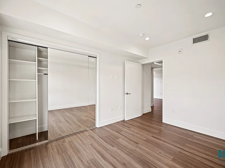 Bedroom with Mirrored Closet with Shelving, Recessed Lighting, and Vinyl Flooring
