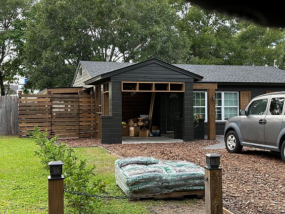 Carport fits vehicle and can also serve as another staging area for guests if need be_ even has a designer chandelier hanging in the ceiling!