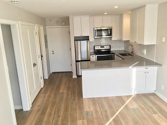 Living room, looking toward the breakfast bar and kitchen