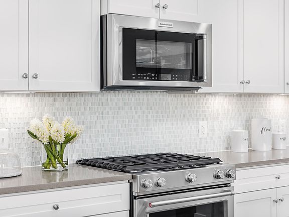 Model RepresentationGorgeous White Cabinetry and Stainless Steel Appliances in the Ethan Kitchen loc