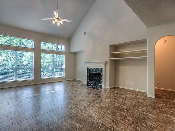 Family room approximately 19x18 has space for a large TV, vaulted ceilings and incredible windows! 20x20 tile throughout the first floor.