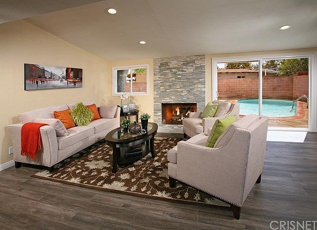 The living room is bathed in natural light from a