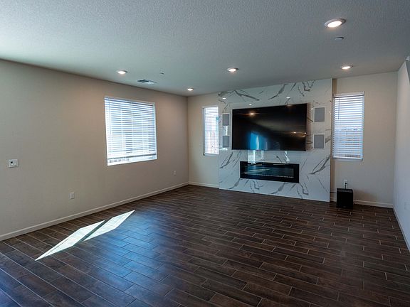 Spacious 85" television with electric fireplace and custom build entertainment center. Incredible sound and tv watching experience.