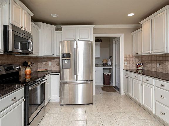 Kitchen with stainless steel appliances and tile floors and a super quiet dishwasher.