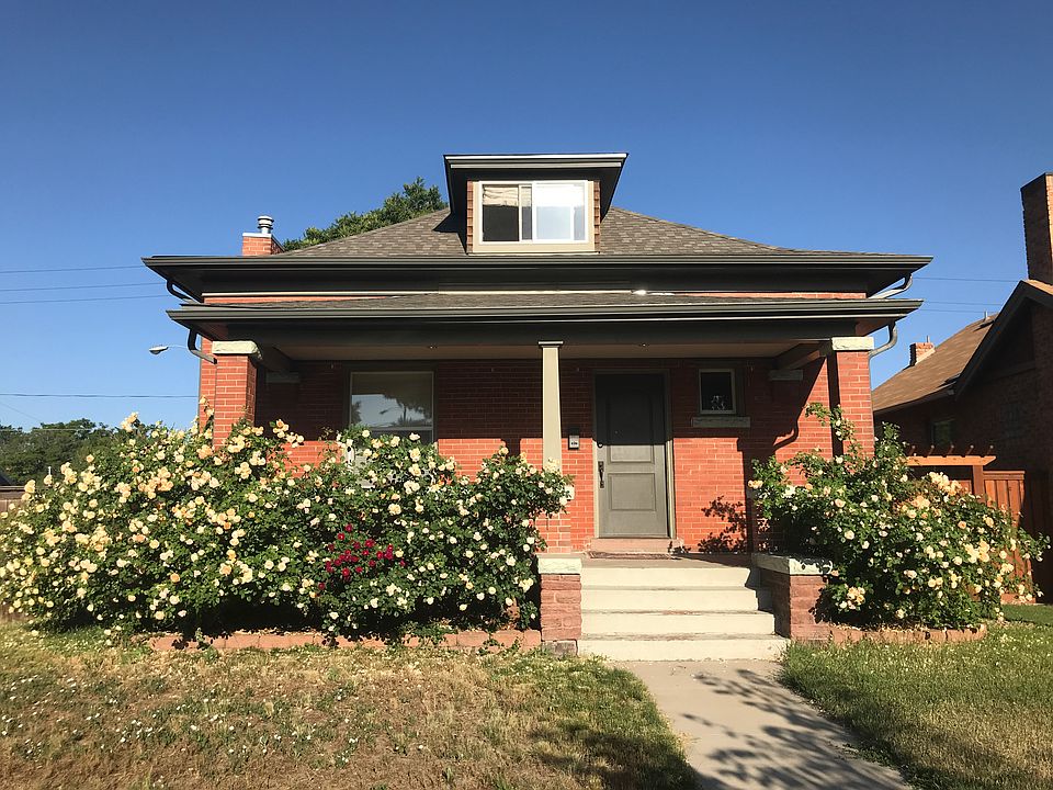 Climbing roses adorn the large front porch, offering a wonderfully fragrant place to relax in summer.