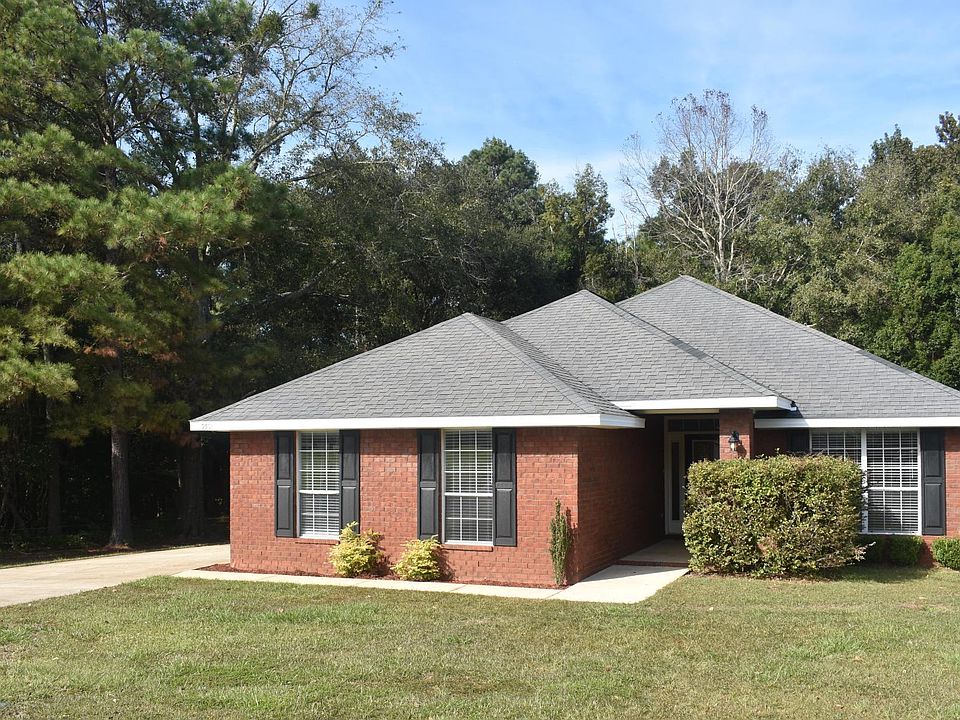Woods behind and to the left of this 4 sided brick home at the end of a quiet street.