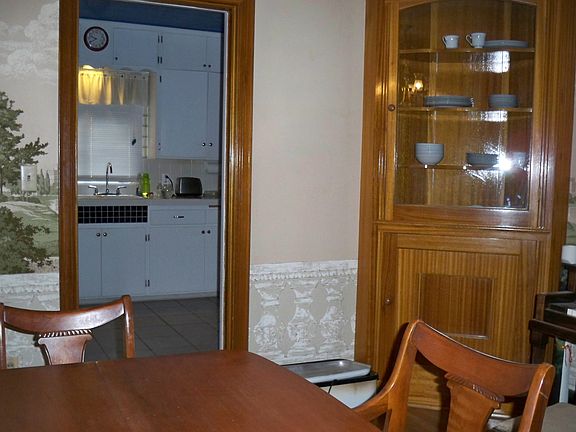 dining area leads to kitchen w/ elegant china hutch