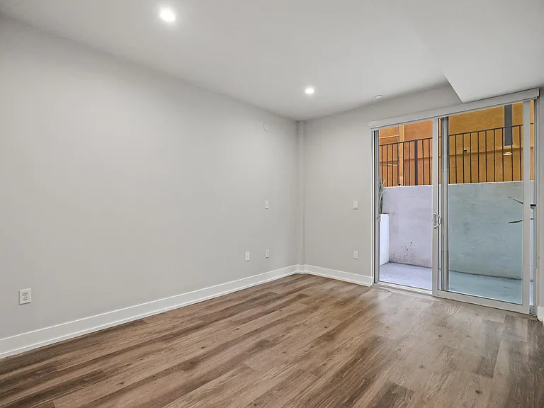 Bedroom with Mirrored Closet, Vinyl Flooring, and Balcony with Private Entrance