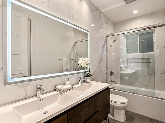 Bath attached to second bedroom also has a second door from the living area